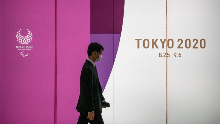 Japanese Government And IOC Agree To Postpone Olympic Games
TOKYO, JAPAN - MARCH 25: A man passes an advert for the Tokyo 2020 Olympics on March 25, 2020 in Tokyo, Japan. Following yesterdays announcement that the Tokyo 2020 Olympics will be postponed to 2021 because of the ongoing Covid-19 coronavirus pandemic, IOC officials have said they hope to confirm a new Olympics date as soon as possible. (Photo by Carl Court/Getty Images)