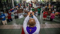 Di Filipina, para tuna wisma yang berlindung di sebuah sekolah Katolik ikut serta merayakan Kamis Putih. Ezra Acayan/Getty Images.