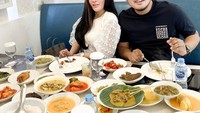 Banyak momen kuliner yang ia bagikan melalui laman Instagramnya sendiri. Seperti yang tampak pada foto ini, bersama dengan suami tercinta, mereka makan dengan berpiring-piring lauk. Foto: : Instagram @shandypurnamasari