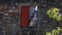 Seorang umat Kristiani di kawasan Islamabad, Pakistan, mengikuti ibadah Minggu Paskah dari dalam rumahnya.