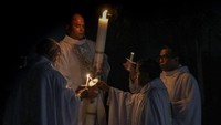 Romo Stefanus I Kadek Adi Subrata menyalakan lilin diikuti sejumlah pastur pada ibadah malam Paskah atau Sabtu Suci di Gereja Santo Arnoldus Janssen, Kota Bekasi, Jawa Barat, Sabtu (11/4/2020). Antara Foto//Paramayuda.