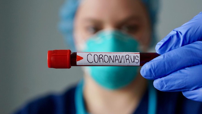 Nurse wearing respirator mask holding a positive blood test result for the new rapidly spreading Coronavirus, originating in Wuhan, China