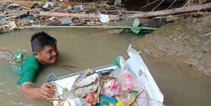 Wahyudi saat mengangkut sampah di sungai (dok. Istimewa)