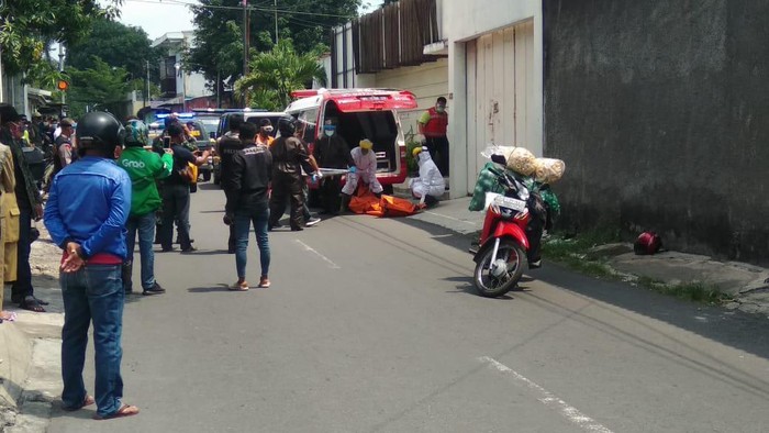 Petugas ber-APD evakuasi pemotor yang tewas di jalanan Solo, Senin (13/4/2020).