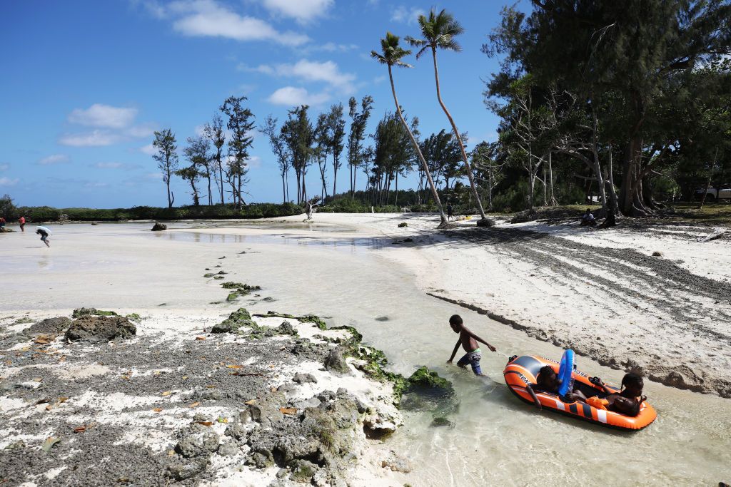 EFATE, VANUATU - NOVEMBER 30: Kids play at Eton Beach on November 30, 2019 in Efate, Vanuatu. Satellite data show sea level has risen about 6mm per year around Vanuatu since 1993, a rate nearly twice the global average, while temperatures have been increasing since 1950. 25 percent of Vanuatu's 276,000 citizens lost their homes in 2015 when Cyclone Pam, a category 5 storm, devastated the South Pacific archipelago of 83 islands while wiping out two-thirds of its GDP. Scientists have forecast that the strength of South Pacific cyclones will increase because of global warming. Vanuatu's government is considering suing the world's major pollution emitters in a radical effort to confront global warming challenges and curb global emissions, to which it is a very small contributor. (Photo by Mario Tama/Getty Images)