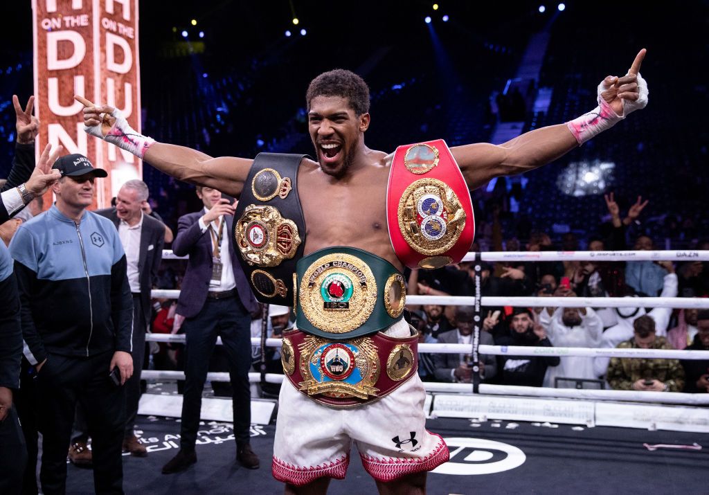 DIRIYAH, SAUDI ARABIA - DECEMBER 07:  Anthony Joshua poses for a photo with the IBF, WBA, WBO & IBO World Heavyweight Title belts after the IBF, WBA, WBO & IBO World Heavyweight Title Fight between Andy Ruiz Jr and Anthony Joshua during the Matchroom Boxing 'Clash on the Dunes' show at the Diriyah Season on December 07, 2019 in Diriyah, Saudi Arabia (Photo by Richard Heathcote/Getty Images)