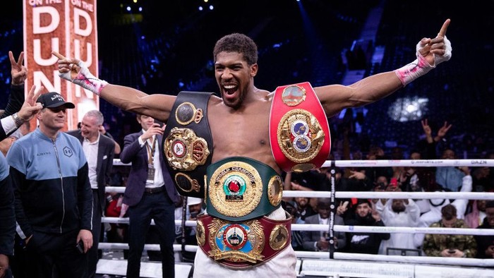 DIRIYAH, SAUDI ARABIA - DECEMBER 07:  Anthony Joshua poses for a photo with the IBF, WBA, WBO & IBO World Heavyweight Title belts after the IBF, WBA, WBO & IBO World Heavyweight Title Fight between Andy Ruiz Jr and Anthony Joshua during the Matchroom Boxing Clash on the Dunes show at the Diriyah Season on December 07, 2019 in Diriyah, Saudi Arabia (Photo by Richard Heathcote/Getty Images)