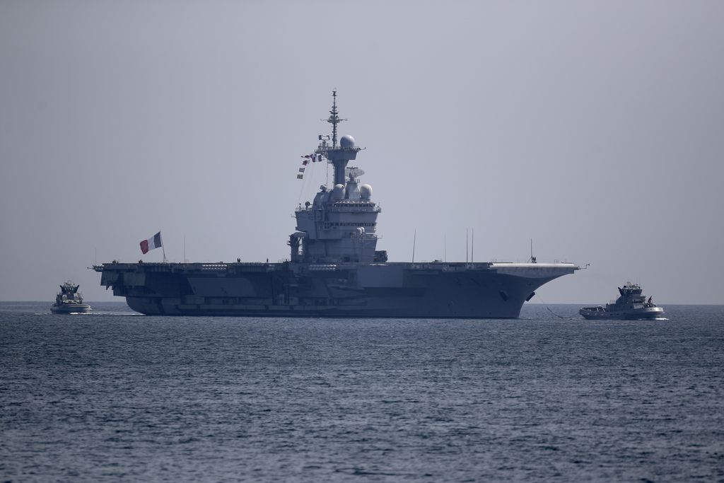 The French aircraft carrier Charles de Gaulle arrives in the bay of Toulon, southern France, Sunday April 12, 2020. The Defense Ministry said in a statement that around 40 sailors showed symptoms compatible with COVID-19, the disease the coronavirus causes. The new coronavirus causes mild or moderate symptoms for most people, but for some, especially older adults and people with existing health problems, it can cause more severe illness or death. (AP Photo/Daniel Cole)