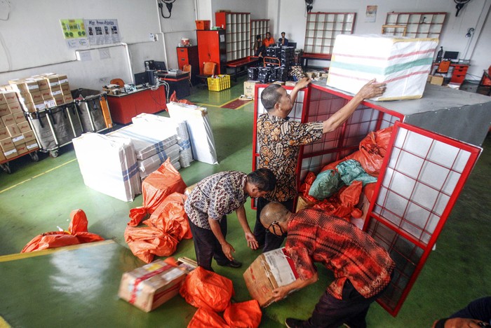 Petugas memilah paket kiriman barang di Kantor Pos, Cibinong, Bogor, Jawa Barat, Jumat (17/4/2020). Menurut petugas, dimasa penerapan Pembatasan Sosial Berskala Besar (PSBB), volume pengiriman paket pos khusus belanja online mengalami  kenaikan rata-rata 10 persen dari biasanya. ANTARA FOTO/Yulius Satria Wijaya/pras.