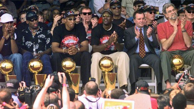 FILE - In this June 10, 1998, file photo,  Cicago Bulls' Michael Jordan reaches high above teammates Dennis Rodman, left, Scottie Pippen, and Scott Burrell (24) for a rebound against the Utah Jazz in the second half of Game 4 in the NBA Finals in Chicago. Jordan described his final NBA championship season with the Chicago Bulls as a 