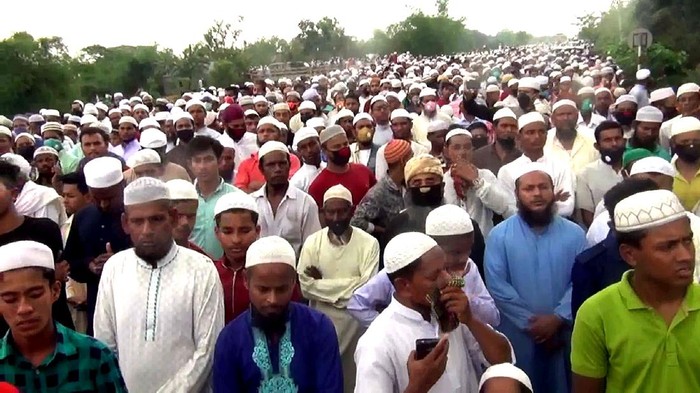 In this Saturday, April 18, 2020 photo, thousands of Bangladeshi Muslims gather to attend the funeral of a popular Islamic preacher defying a nationwide lockdown to curb the spread of the new coronavirus at the central district of Brahmanbaria, Bangladesh. Bangladesh, a nation of 160 million people, is struggling to enforce ban on large gatherings. (AP Photo/Masuk Hridoy)