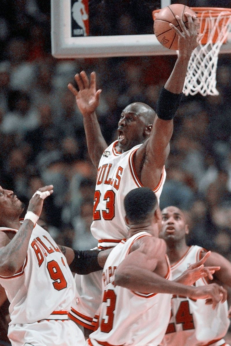 The Last Dance Jordan Basketball FILE - In this June 10, 1998, file photo, Cicago Bulls' Michael Jordan reaches high above teammates Dennis Rodman, left, Scottie Pippen, and Scott Burrell (24) for a rebound against the Utah Jazz in the second half of Game 4 in the NBA Finals in Chicago. Jordan described his final NBA championship season with the Chicago Bulls as a