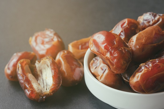 Ramadan dates or kurma for iftar in a box. Isolated on black, studio shot.