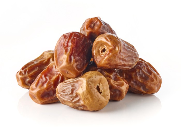 Ramadan dates or kurma for iftar in a box. Isolated on black, studio shot.