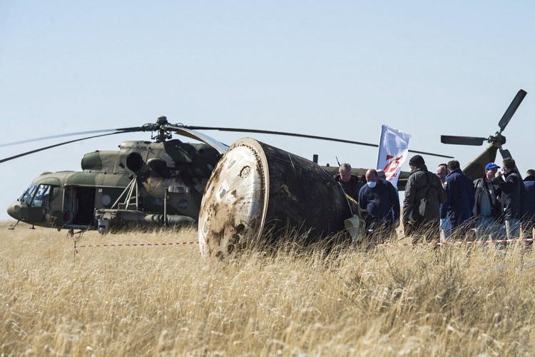 In this handout photo released by Gagarin Cosmonaut Training Centre (GCTC), Roscosmos space agency, U.S. astronauts Andrew Morgan, left, Jessica Meir, right, and Russian cosmonaut Oleg Skripochka sit in chairs shortly after the landing of the Russian Soyuz MS-15 space capsule near Kazakh town of Dzhezkazgan, Kazakhstan, Friday, April 17, 2020. An International Space Station crew has landed safely after more than 200 days in space. The Soyuz capsule carrying NASA astronauts Andrew Morgan, Jessica Meir and Russian space agency Roscosmos Oleg Skripochka touched down on Friday on the steppes of Kazakhstan. (Andrey Shelepin, Gagarin Cosmonaut Training Centre (GCTC), Roscosmos space agency, via AP)