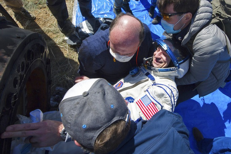 In this handout photo released by Gagarin Cosmonaut Training Centre (GCTC), Roscosmos space agency, rescue team members get out of the capsule U.S. astronaut Andrew Morgan shortly after the landing of the Russian Soyuz MS-15 space capsule near Kazakh town of Dzhezkazgan, Kazakhstan, Friday, April 17, 2020. An International Space Station crew has landed safely after more than 200 days in space. The Soyuz capsule carrying NASA astronauts Andrew Morgan, Jessica Meir and Russian space agency Roscosmos Oleg Skripochka touched down on Friday on the steppes of Kazakhstan. (Andrey Shelepin, Gagarin Cosmonaut Training Centre (GCTC), Roscosmos space agency, via AP)