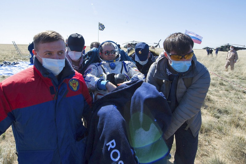 In this handout photo released by Gagarin Cosmonaut Training Centre (GCTC), Roscosmos space agency, U.S. astronauts Andrew Morgan, left, Jessica Meir, right, and Russian cosmonaut Oleg Skripochka sit in chairs shortly after the landing of the Russian Soyuz MS-15 space capsule near Kazakh town of Dzhezkazgan, Kazakhstan, Friday, April 17, 2020. An International Space Station crew has landed safely after more than 200 days in space. The Soyuz capsule carrying NASA astronauts Andrew Morgan, Jessica Meir and Russian space agency Roscosmos' Oleg Skripochka touched down on Friday on the steppes of Kazakhstan. (Andrey Shelepin, Gagarin Cosmonaut Training Centre (GCTC), Roscosmos space agency, via AP)
