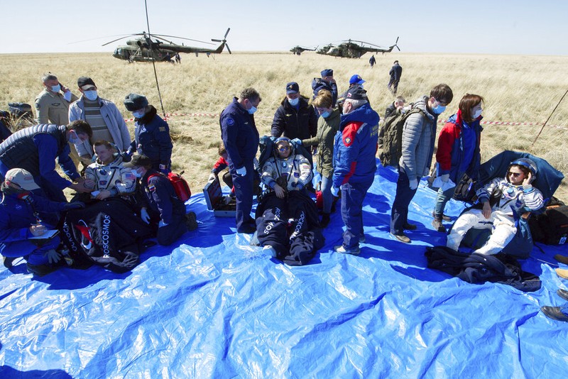 In this handout photo released by Gagarin Cosmonaut Training Centre (GCTC), Roscosmos space agency, U.S. astronauts Andrew Morgan, left, Jessica Meir, right, and Russian cosmonaut Oleg Skripochka sit in chairs shortly after the landing of the Russian Soyuz MS-15 space capsule near Kazakh town of Dzhezkazgan, Kazakhstan, Friday, April 17, 2020. An International Space Station crew has landed safely after more than 200 days in space. The Soyuz capsule carrying NASA astronauts Andrew Morgan, Jessica Meir and Russian space agency Roscosmos' Oleg Skripochka touched down on Friday on the steppes of Kazakhstan. (Andrey Shelepin, Gagarin Cosmonaut Training Centre (GCTC), Roscosmos space agency, via AP)
