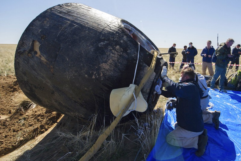 In this handout photo released by Gagarin Cosmonaut Training Centre (GCTC), Roscosmos space agency, U.S. astronauts Andrew Morgan, left, Jessica Meir, right, and Russian cosmonaut Oleg Skripochka sit in chairs shortly after the landing of the Russian Soyuz MS-15 space capsule near Kazakh town of Dzhezkazgan, Kazakhstan, Friday, April 17, 2020. An International Space Station crew has landed safely after more than 200 days in space. The Soyuz capsule carrying NASA astronauts Andrew Morgan, Jessica Meir and Russian space agency Roscosmos' Oleg Skripochka touched down on Friday on the steppes of Kazakhstan. (Andrey Shelepin, Gagarin Cosmonaut Training Centre (GCTC), Roscosmos space agency, via AP)