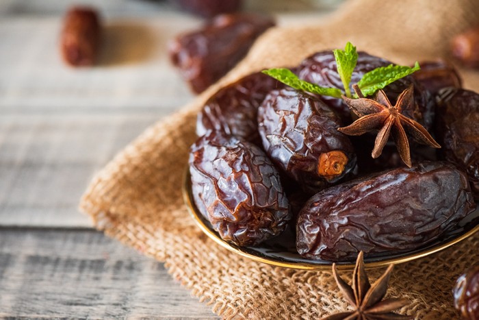 Ramadan dates or kurma for iftar in a box. Isolated on black, studio shot.