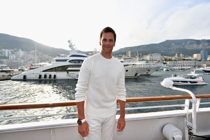 MONTE-CARLO, MONACO - MAY 26: NFL star Tom Brady poses for a photo after throwing a ball to Daniel Ricciardo of Australia and Red Bull Racing on the TAG Heuer boat after qualifying for the Monaco Formula One Grand Prix at Circuit de Monaco on May 26, 2018 in Monte-Carlo, Monaco.  (Photo by Dan Mullan/Getty Images)