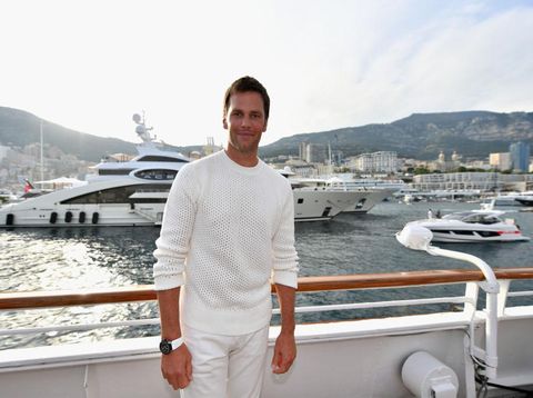 963377730 MONTE-CARLO, MONACO - MAY 26: NFL star Tom Brady poses for a photo after throwing a ball to Daniel Ricciardo of Australia and Red Bull Racing on the TAG Heuer boat after qualifying for the Monaco Formula One Grand Prix at Circuit de Monaco on May 26, 2018 in Monte-Carlo, Monaco. (Photo by Dan Mullan/Getty Images)