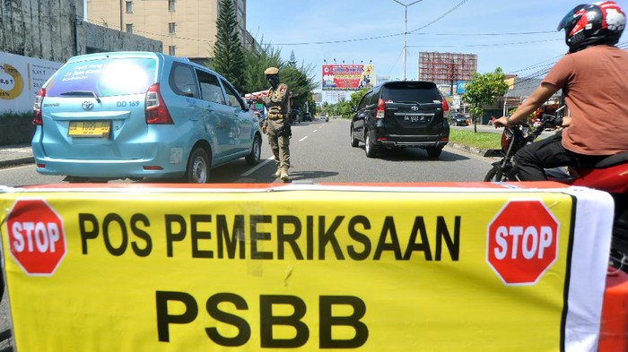 Ilustrasi PSBB Petugas memeriksa penumpang di dalam kendaraan yang melintas di Posko Check Point Pembatasan Sosial Berskala Besar (PSBB) di Air Tawar, Padang, Sumatera Barat, Rabu (22/4/2020). PSBB diterapkan di Padang dan kabupaten/ kota lain di provinsi itu mulai Rabu (22/4/2020) hingga 5 Mei 2020 untuk menghentikan penyebaran COVID-19, diantaranya dengan membatasi aktivitas di luar rumah, wajib menggunakan masker serta pembatasan jumlah penumpang kendaraan roda empat dan roda dua.