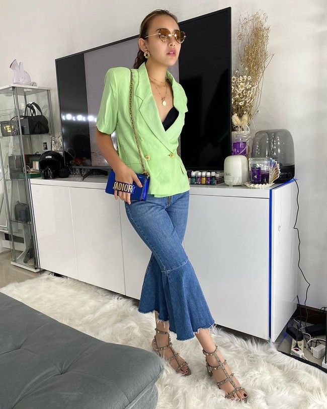 Salah satunya dia pernah bergaya dengan shoulder bag keluaran Dior, yang dipadukan dengan blazer hijau dan jeans biru berpotongan wide leg. Foto: Instagram/@amandamanopo