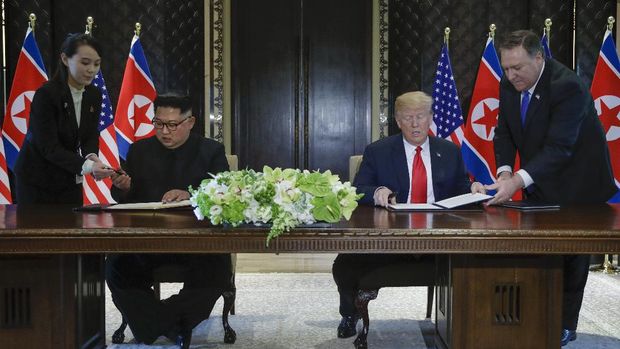 FILE - In this June 12, 2018, file photo, North Korea leader Kim Jong Un, center left, and U.S. President Donald Trump, center right, prepare to sign a document at the Capella resort on Sentosa Island in Singapore. At the last minute, Kim's sister, Kim Yo-jong, far left, provided a pen of her own for his use. Kim Jong Un's disappearance from the public eye is raising speculation about not only his health but also about who's next in line to run North Korea if anything happens to the leader. Some experts say his sister and close associate Kim Yo Jong is most likely since North Korea has been ruled by the Kim family for seven decades.  (AP Photo/Evan Vucci, File)