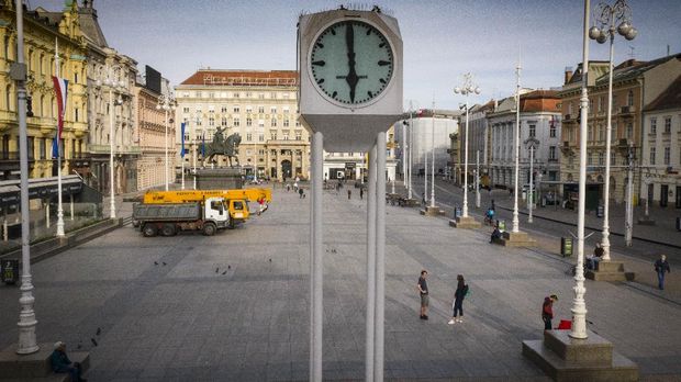 A view of the clock at an almost empty main square because of the coronavirus lockdown, where machinery is parked for rebuilding works after the recent earthquake, in Zagreb, Croatia at 1800 on Friday, April 24, 2020. (AP Photo/Darko Bandic)