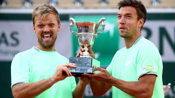 PARIS, FRANCE - JUNE 08: Kevin Krawietz of Germany and partner Andreas Mies of Germany hold the trophy as they celebrate victory during the mens doubles final against Jeremy Chardy of France and Fabrice Martin of France during Day fourteen of the 2019 French Open at Roland Garros on June 08, 2019 in Paris, France. (Photo by Julian Finney/Getty Images)