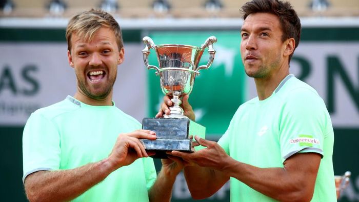 1154637196 PARIS, FRANCE - JUNE 08: Kevin Krawietz of Germany and partner Andreas Mies of Germany hold the trophy as they celebrate victory during the mens doubles final against Jeremy Chardy of France and Fabrice Martin of France during Day fourteen of the 2019 French Open at Roland Garros on June 08, 2019 in Paris, France. (Photo by Julian Finney/Getty Images)