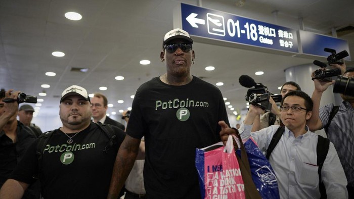 Former NBA basketball player Dennis Rodman of the US gestures as he arrives to check-in for his flight to North Korea at Beijings international airport on June 13, 2017. - Flamboyant former NBA star Dennis Rodman is expected to arrive in Pyongyang on June 13, US media reported, with the heavily-tattooed former player apparently set for another round of his controversial 