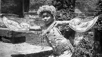 Ni Kunitan menampilkan Tarian Legong dalam sebuah acara pada 1950 lalu. Penari tampil dengan mengenakan busana khas Bali dan memegang dua kipas. Richard Harrington/Three Lions/Getty Images.