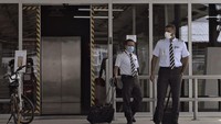Pilot-pilot AirAsia tampak mengenakan masker saat menunggu mobil jemputan untuk menuju ke gedung Terminal 2 Bandara Internasional Kuala Lumpur (KLIA2) pada 29 April 2020 di Kuala Lumpur, Malaysia. 