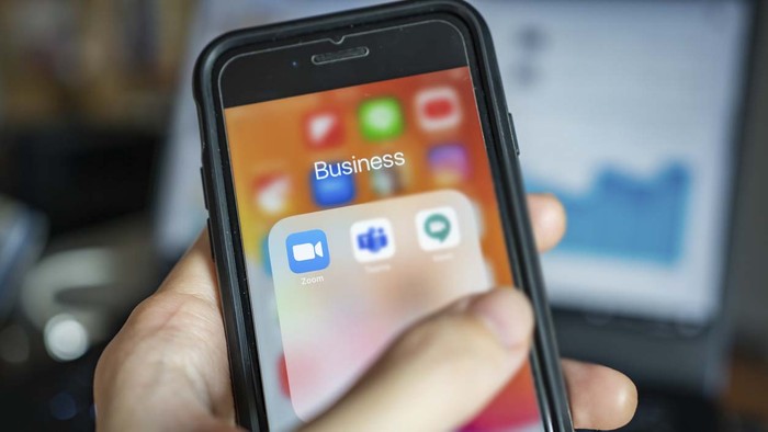 Bangkok, Thailand - April 1, 2020 : iPhone 7 showing its screen with popular online meeting applications which are Zoom, Microsoft Teams and Hangouts Meet by Google.
