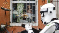 Sejumlah warga tampak terhibur saat tokoh karakter dalam film Star Wars melintas di depan rumahnya. Bahkan mereka juga sempat mengabadikan superhero tersebut.