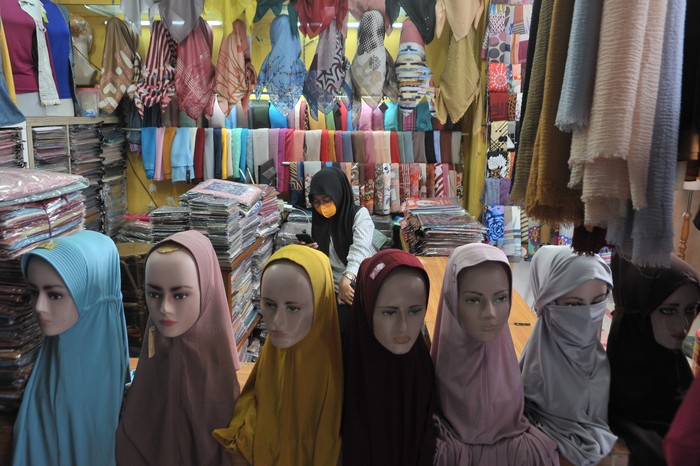 Pedagang melayani konsumen yang berbelanja busana muslim di pusat perbelanjaan Pasar Aceh, Banda Aceh, Aceh, Jumat (1/5/2020). Pedagang yang berjualan busana muslim di pusat perbelanjaan itu mengeluh sejak sebulan terakhir omset penjualan menurun hingga 75 persen akibat kurangnya aktivitas warga di luar rumah terkait wabah COVID-19. ANTARA FOTO/Ampelsa/wsj.