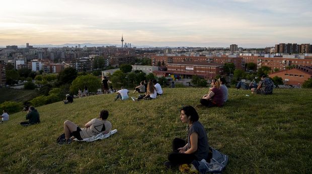 People sit in the Cerro del Tio Pio park in Madrid, Spain, Spain, Sunday, May 3, 2020. On Saturday, Spaniards were able to go outdoors to do exercise for the first time in seven weeks since the lockdown began to battle the coronavirus outbreak. (AP Photo/Manu Fernandez)