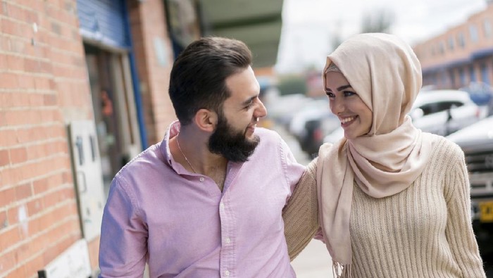 Portrait of a loving young Muslim couple smiling on the street - lifestyle concepts