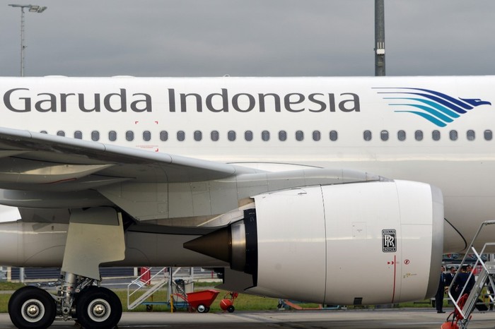 This illustration picture taken on November 15, 2019 shows the logo of a Garuda Indonesia Airbus A330 aircraft parked on the tarmac at the Airbus delivery center in Colomiers, southwestern France. (Photo by PASCAL PAVANI / AFP)