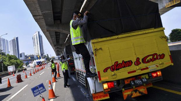 Petugas kepolisian memeriksa bak truk di jalan tol Jakarta-Cikampek, Cikarang Barat, Jawa Barat, Kamis (7/5/2020). Pemerintah menyatakan masyarakat Indonesia tetap dilarang mudik, tapi ada pengecualian bagi ASN, prajurit TNI dan Polri, pegawai BUMN, lembaga usaha, dan LSM yang berhubungan dengan percepatan penanganan COVID-19 serta masyarakat yang keluarganya meninggal atau keluarga sakit, repatriasi, pekerja migran Indonesia, TKI, dan pelajar atau mahasiswa yang akan kembali ke tanah air. ANTARA FOTO/Sigid Kurniawan/aww.