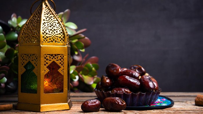 1147399942 Dates and Arabic style lamp on a table with copy space