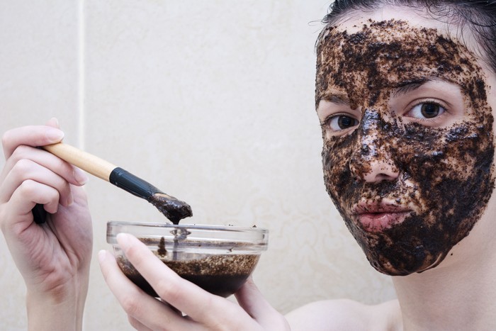 Caucasian model, age 20-29 years old using a face scrub made out of coffee, honey and milk