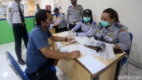 Petugas Dishub melakukan pengecekan syarat-syarat sebelum menginzinkan penumpang pergi naik bus.