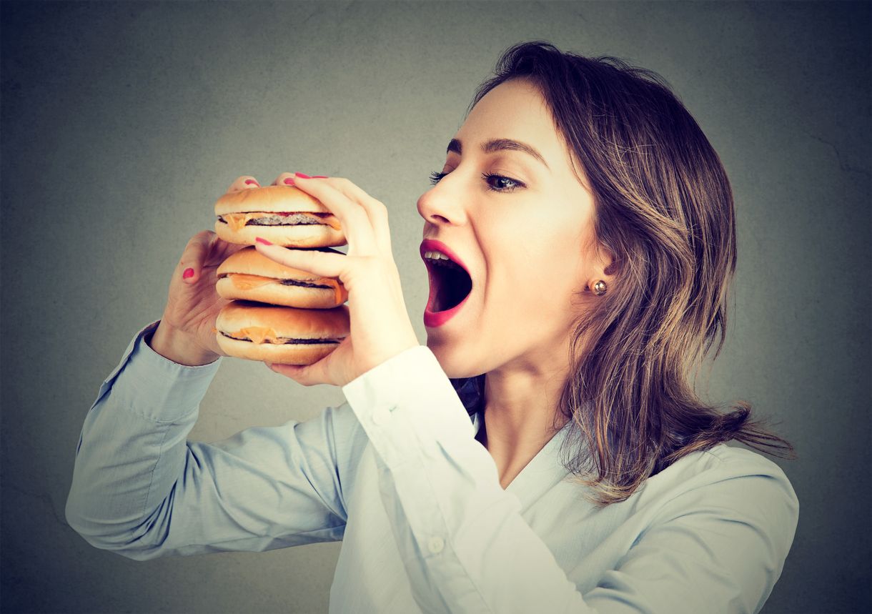 Woman eating craving a tasty double burger