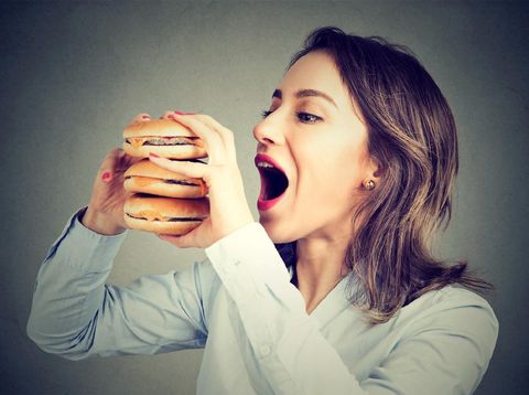 Woman eating craving a tasty double burger