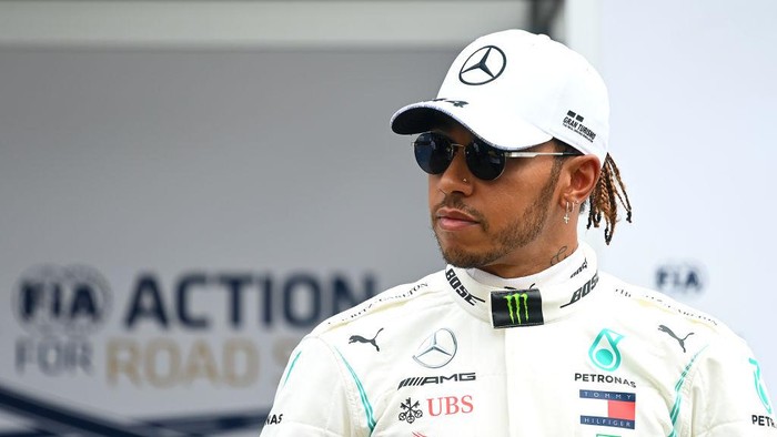 MELBOURNE, AUSTRALIA - MARCH 12: Lewis Hamilton of Great Britain and Mercedes GP looks on in the Paddock during previews ahead of the F1 Grand Prix of Australia at Melbourne Grand Prix Circuit on March 12, 2020 in Melbourne, Australia. (Photo by Clive Mason/Getty Images)