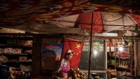 Pedagang pasar dengan bendera Tiongkok di Kota Kashgar, Xinjiang, (29/6/2017). Secara kenegaraan, Uighur Xinjiang masuk ke Tiongkok. Namun secara budaya, Muslim Uighur banyak dipengaruhi oleh tradisi Islam yang sudah mendarah daging sejak abad ke-10 Masehi. 