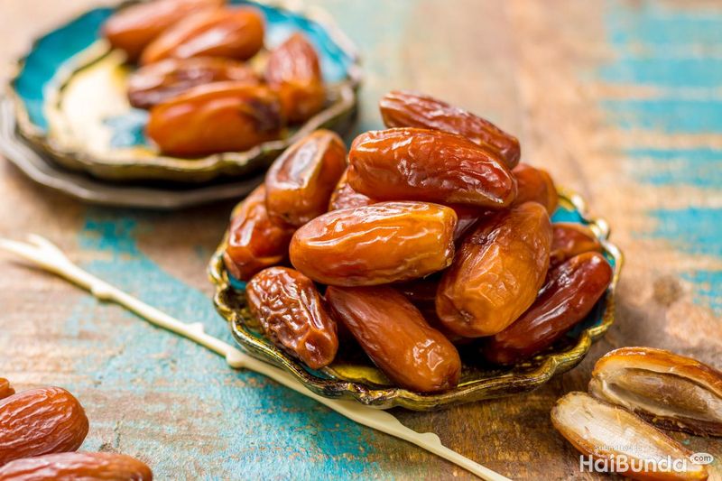 juicy Dried date fruits or kurma, ramadan meal with mint leaf, flat lay